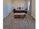 Neutral bedroom with a bench at the foot of the bed at 56315 E 74Th Ave, Strasburg, CO 80136