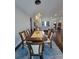Open dining area with hardwood floors, chandelier, and table set with fruit at 56315 E 74Th Ave, Strasburg, CO 80136