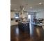 Open-concept kitchen with modern island, stainless steel appliances, and adjacent dining area at 56315 E 74Th Ave, Strasburg, CO 80136