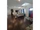 A spacious living room with a large television and hardwood floors at 56315 E 74Th Ave, Strasburg, CO 80136