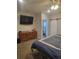 Comfortable bedroom featuring a closet with a modern sliding barn door and TV at 56315 E 74Th Ave, Strasburg, CO 80136