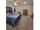 Spacious primary bedroom with ceiling fan, dresser, large bed, and carpet at 56315 E 74Th Ave, Strasburg, CO 80136