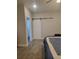 Comfortable bedroom featuring a closet with a modern sliding barn door at 56315 E 74Th Ave, Strasburg, CO 80136