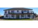 Rear exterior showcasing a second-story deck, walkout basement, and well-maintained lawn at 56315 E 74Th Ave, Strasburg, CO 80136