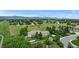 Aerial view showcasing property's well maintained lawn, mature trees, and quiet neighborhood at 5653 Yank St, Arvada, CO 80002