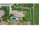 Aerial view of home with pool and landscaped backyard featuring a spacious patio and seating areas at 5653 Yank St, Arvada, CO 80002