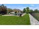Lush backyard featuring a sparkling swimming pool, a seating area, and a meticulously maintained lawn at 5653 Yank St, Arvada, CO 80002