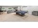 Open basement with plush carpeting features a pool table, bar stools and comfortable seating at 5653 Yank St, Arvada, CO 80002