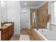 Inviting bathroom with a soaking tub, tiled shower, granite countertop vanity, and ample natural light at 5653 Yank St, Arvada, CO 80002