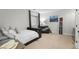 Cozy bedroom with black out curtains, artwork and adjacent sitting area with leather sofa at 5653 Yank St, Arvada, CO 80002