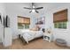 Cozy bedroom with a twin bed, plush carpet, neutral decor, and sun-filled windows at 5653 Yank St, Arvada, CO 80002
