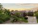 Beautifully landscaped front yard with mature trees, stone accents, and a long driveway at 5653 Yank St, Arvada, CO 80002
