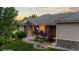 Close up of the home's facade, showcasing stone accents and a well maintained yard at 5653 Yank St, Arvada, CO 80002