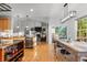 Open kitchen with stainless steel appliances, breakfast bar, and dining area at 5653 Yank St, Arvada, CO 80002
