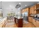 Spacious kitchen with island, seating, stainless appliances and abundant natural light at 5653 Yank St, Arvada, CO 80002