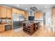 Spacious kitchen featuring a large island with wine rack, granite countertops, and stainless steel appliances at 5653 Yank St, Arvada, CO 80002