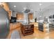 Gourmet kitchen with stainless steel appliances, island, and wine storage at 5653 Yank St, Arvada, CO 80002