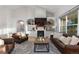 Well-lit living room featuring fireplace, built-in shelving, and hardwood floors at 5653 Yank St, Arvada, CO 80002