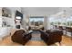 Cozy living room with a brick fireplace, large windows, and comfortable seating at 5653 Yank St, Arvada, CO 80002