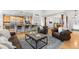 Cozy living room with open layout, breakfast bar, and hardwood floors at 5653 Yank St, Arvada, CO 80002