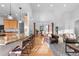 Open-concept living area with breakfast bar, hardwood floors, and plenty of light at 5653 Yank St, Arvada, CO 80002