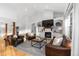 Bright living room with fireplace, large windows and comfortable leather seating at 5653 Yank St, Arvada, CO 80002