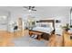 Large main bedroom boasts hardwood floors, a ceiling fan, tray ceilings, and natural light at 5653 Yank St, Arvada, CO 80002