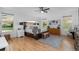 Sun-filled main bedroom featuring hardwood floors, neutral decor, and large windows with scenic views at 5653 Yank St, Arvada, CO 80002