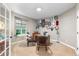 Bright home office featuring neutral carpet, built-in shelves, and a large window providing natural light at 5653 Yank St, Arvada, CO 80002