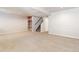 Basement space featuring neutral carpeting, recessed lighting, wooden shelving and stairs to the upper level at 531 Saber Creek Dr, Monument, CO 80132