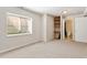 Cozy basement area with window, built-in shelves and access to a bathroom for functionality and comfort at 531 Saber Creek Dr, Monument, CO 80132
