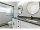 Modern bathroom features double sinks, gray countertops, stylish fixtures, framed mirrors and a glass shower at 531 Saber Creek Dr, Monument, CO 80132