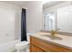 Bathroom with shower and tub combo, vanity with a single sink, and well-lit mirror at 531 Saber Creek Dr, Monument, CO 80132