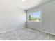 This serene bedroom boasts a large window, offering views of lush trees and a blue sky at 531 Saber Creek Dr, Monument, CO 80132