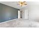 Bedroom featuring a gray accent wall, ceiling fan, and white trim at 531 Saber Creek Dr, Monument, CO 80132