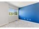This bedroom features a vibrant blue accent wall and a window offering neighborhood views at 531 Saber Creek Dr, Monument, CO 80132