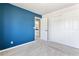 Bedroom with plush carpet, blue accent wall and closet for ample storage; bathroom is attached at 531 Saber Creek Dr, Monument, CO 80132