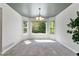 Bright dining room features a stylish chandelier, carpet flooring, and ample natural light from windows at 531 Saber Creek Dr, Monument, CO 80132
