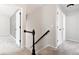 Upstairs hallway with black and white banister and neutral walls at 531 Saber Creek Dr, Monument, CO 80132