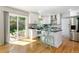 Open kitchen with updated appliances, hardwood floors, and backyard access, perfect for entertaining at 531 Saber Creek Dr, Monument, CO 80132