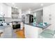 Updated kitchen boasts modern appliances, gray countertops, and a functional island with seating at 531 Saber Creek Dr, Monument, CO 80132