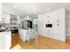 Bright, updated kitchen boasts white cabinetry, stainless steel appliances, and hardwood floors at 531 Saber Creek Dr, Monument, CO 80132