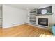 Cozy living room features a fireplace, built-in shelving, and hardwood floors at 531 Saber Creek Dr, Monument, CO 80132