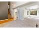 Spacious living area featuring carpeted floors and providing access to the staircase and view of another area at 531 Saber Creek Dr, Monument, CO 80132