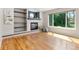 Bright living room with hardwood floors, modern fireplace, built in shelves, and large windows at 531 Saber Creek Dr, Monument, CO 80132