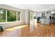 Open living space with hardwood floors, large window, and access to a modern kitchen at 531 Saber Creek Dr, Monument, CO 80132