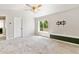 Bright main bedroom with carpet, bench seating, and a ceiling fan at 531 Saber Creek Dr, Monument, CO 80132