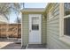 The backyard with green siding, a door, and a small deck at 6819 Reno Dr, Arvada, CO 80002