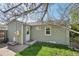This home features green siding, a backyard, and a grassy lawn at 6819 Reno Dr, Arvada, CO 80002