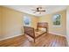 Bedroom features hardwood floors and two sunny windows at 6819 Reno Dr, Arvada, CO 80002